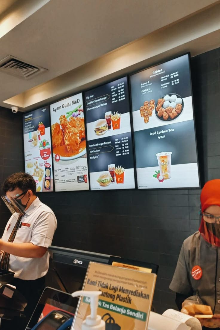 Wall mounted LCD installation by The Hangmaster in restaurant.