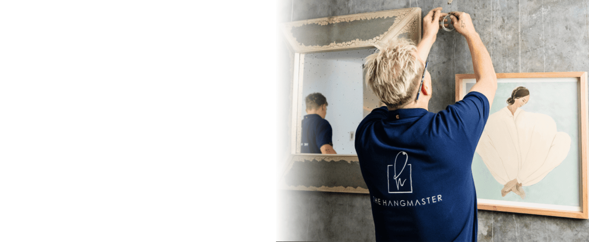 hanging a framed picture on a wall by the Hangmaster.